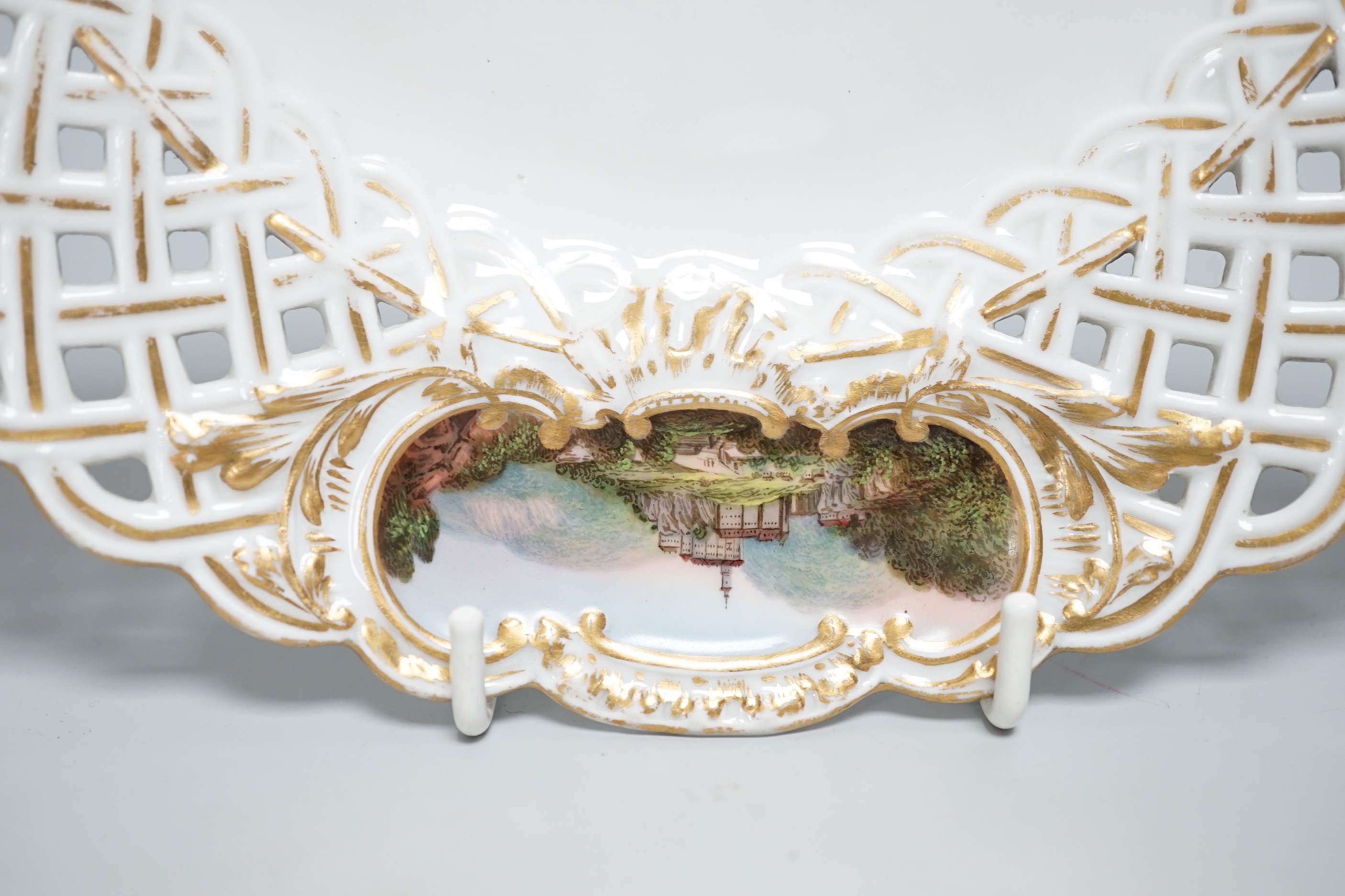 A Meissen topographical reticulated plate, 19th century, painted with named views; Pirna, Wehlstadtel, Weefenstein and Die Lochmukle, 24cm